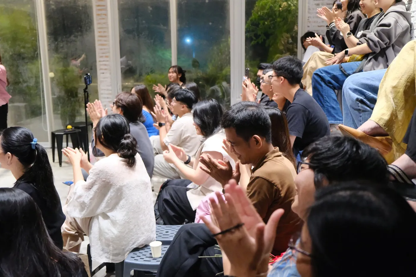Khán giả ngồi gần nhau mỉm cười vỗ tay trong đêm diễn kịch ứng tác tại Saigon Improv House